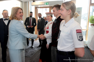 2025. gada Simtgadnieku Salidojums. Cilvēki sarokojas. Foto: Kaspars Ūdris